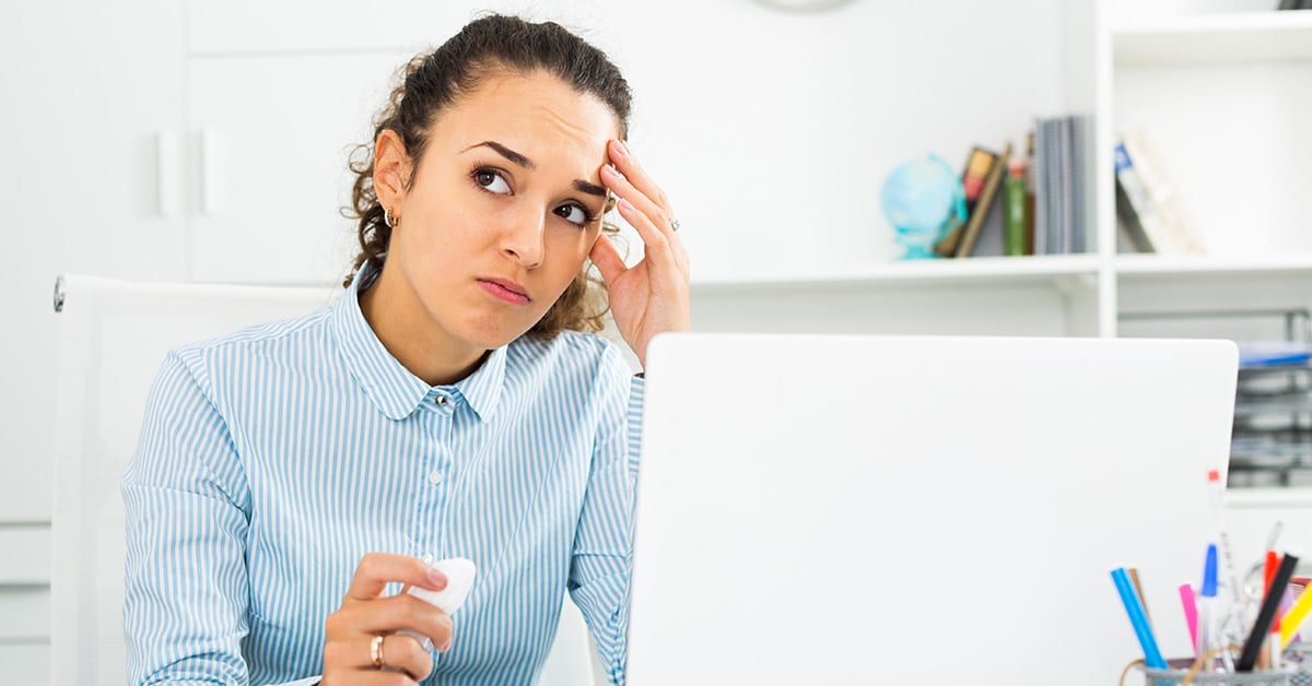 Woman frustrated and looking off into the distance because the client hasn’t delivered content